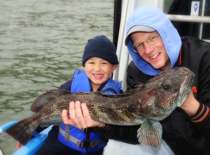 Dad and son dressed warmly for fishing charter trip in San Francisco
