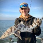guy holding leopard shark